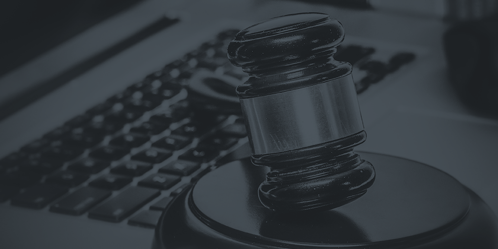 Gavel on a computer. This article is about registering a domain name that uses an active trademark.
