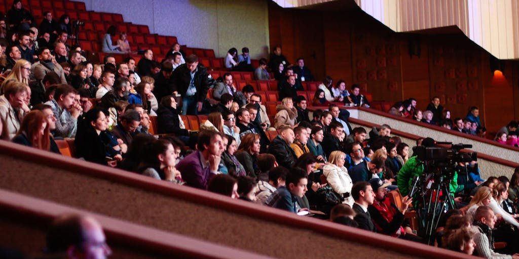 An audience is seated in an auditorium at a Toronto tech event